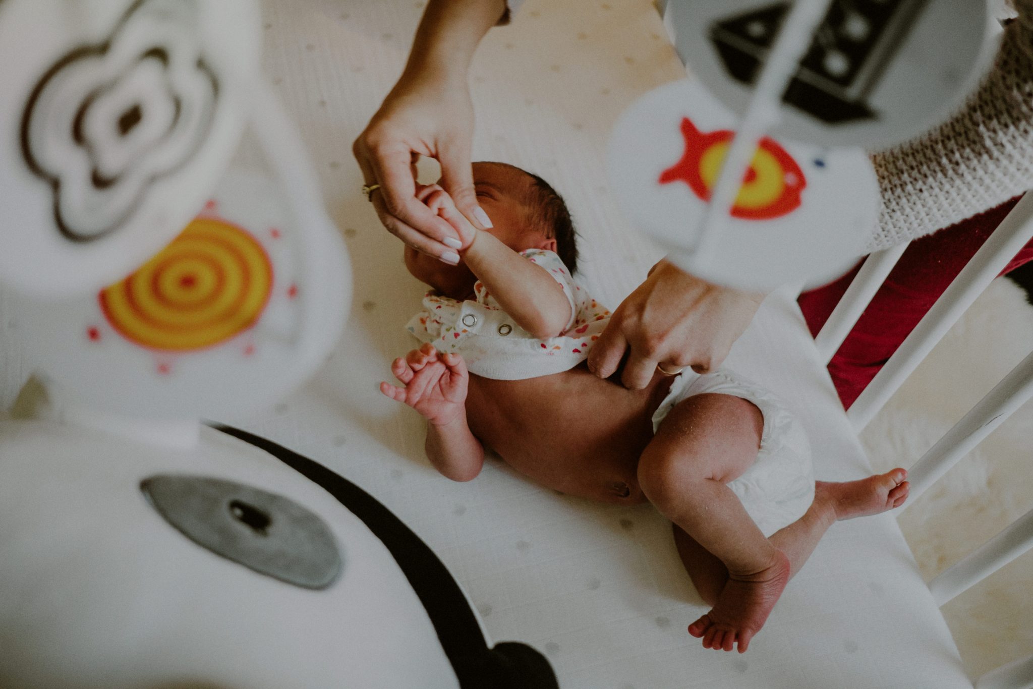 documentary newborn photos of baby getting dressed