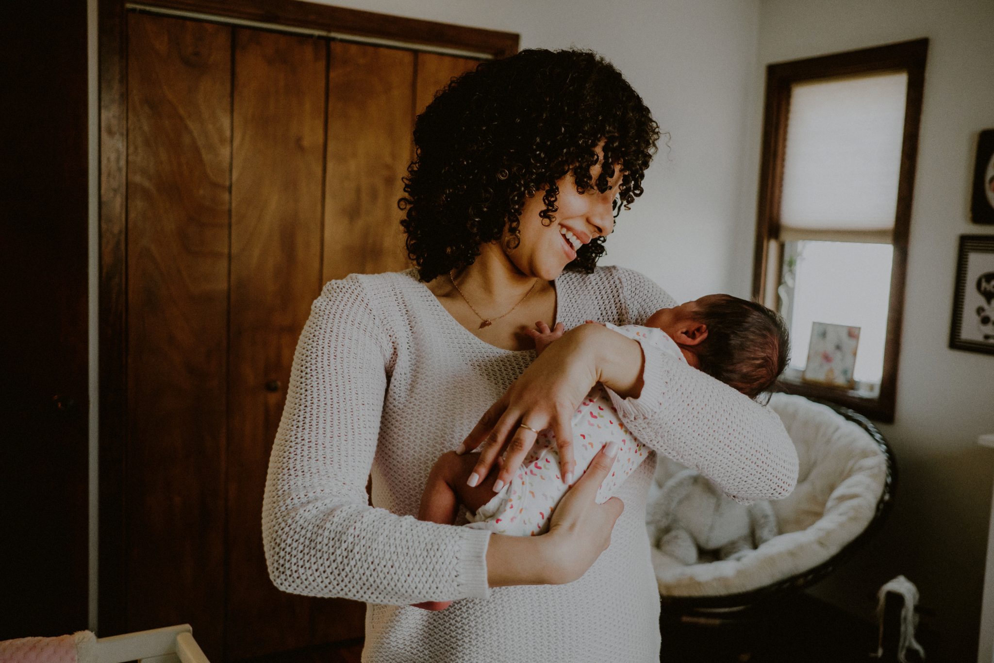 mother holding newborn baby with emotional expression