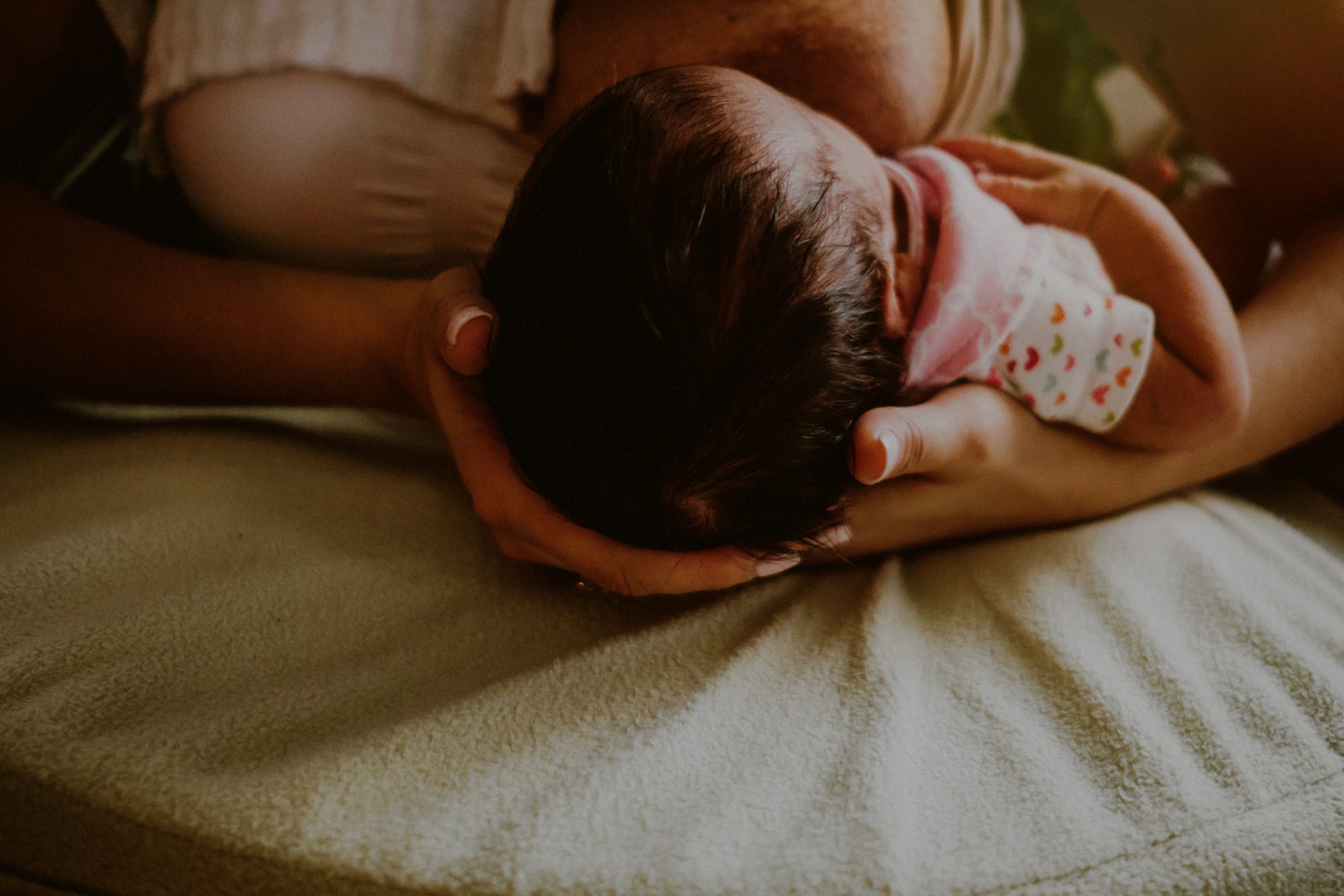 closeup of mother breastfeeding infant, documentary family photographer
