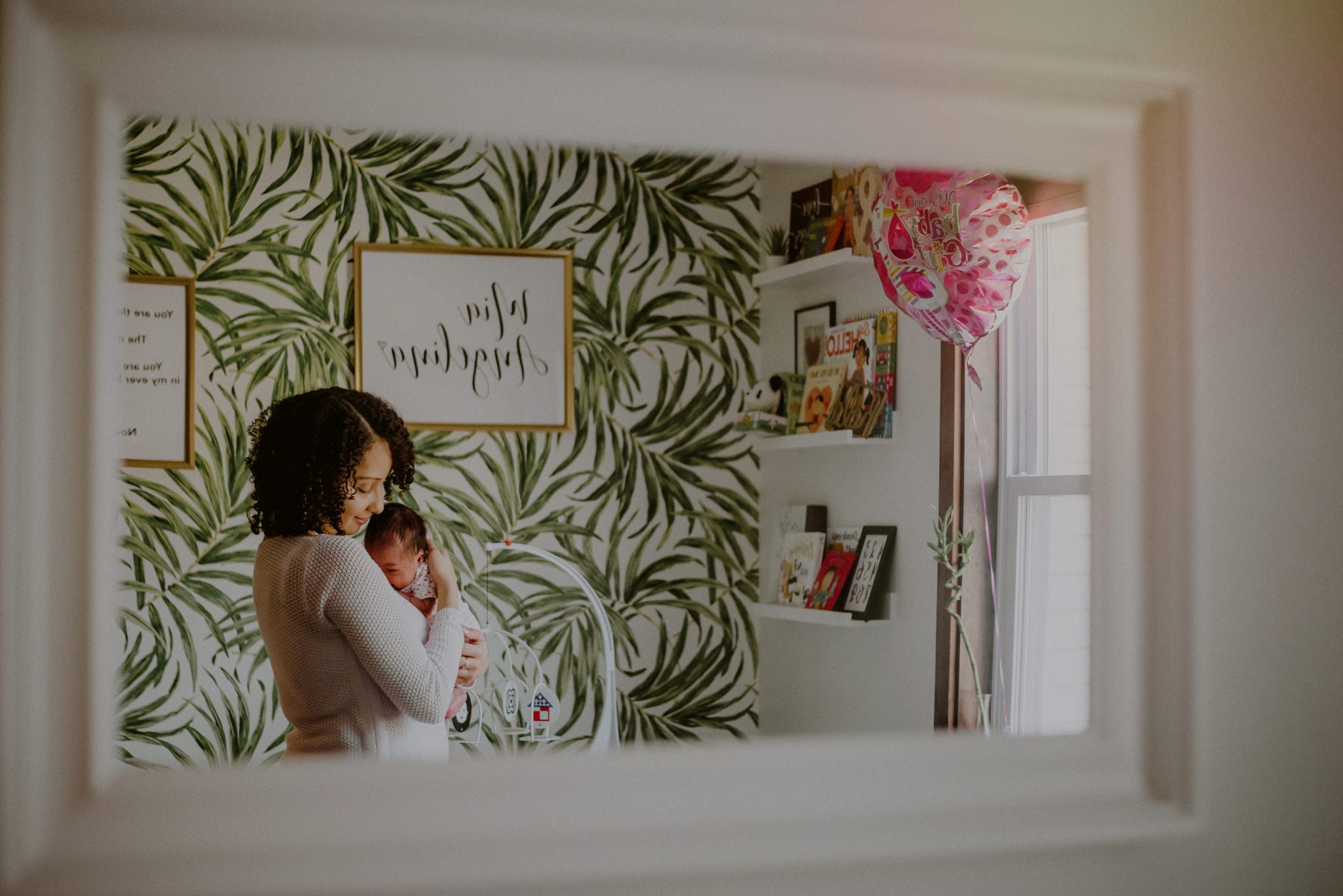 portrait of mother and baby in newly decorated newborn room