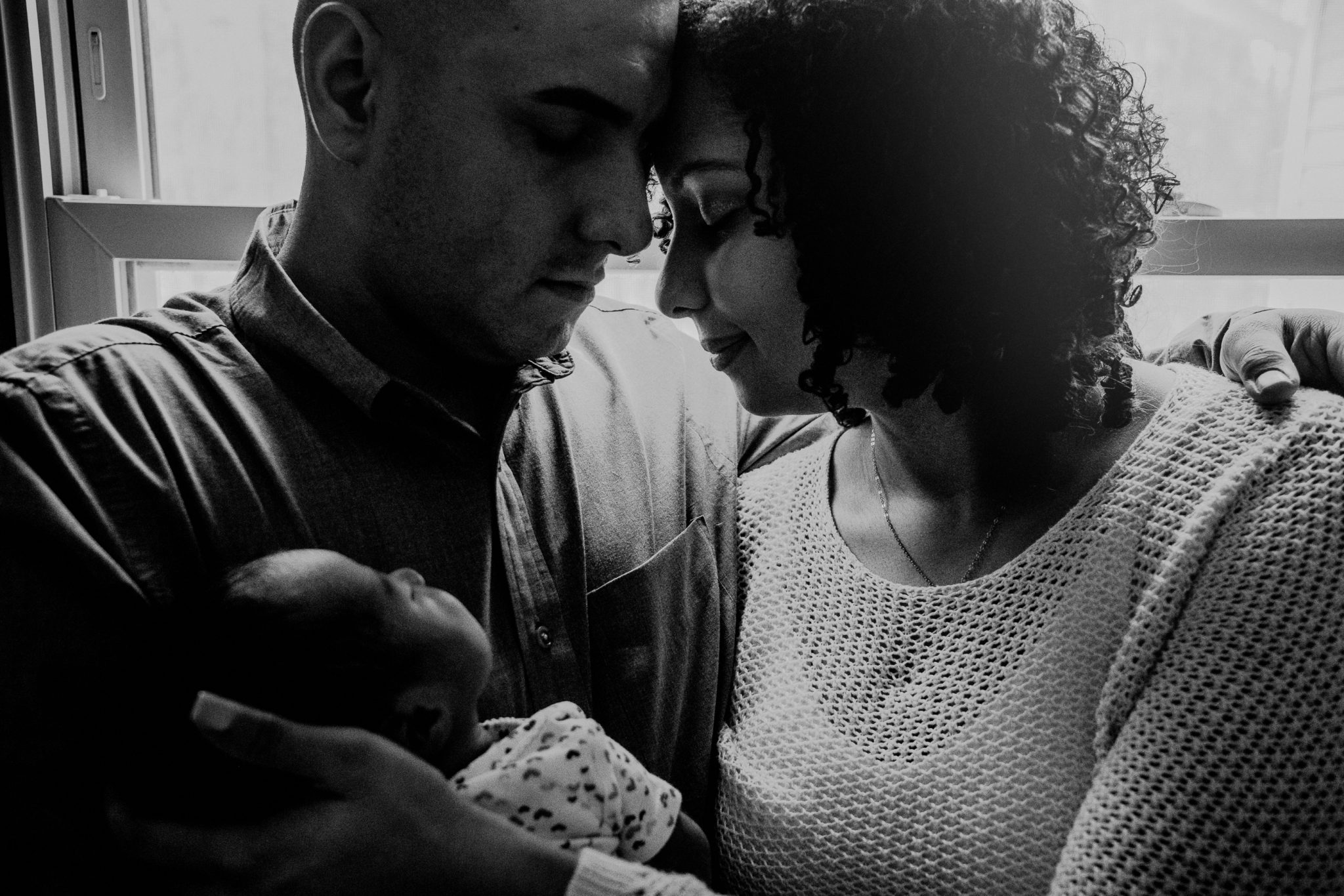 black and white emotional family portrait with newborn