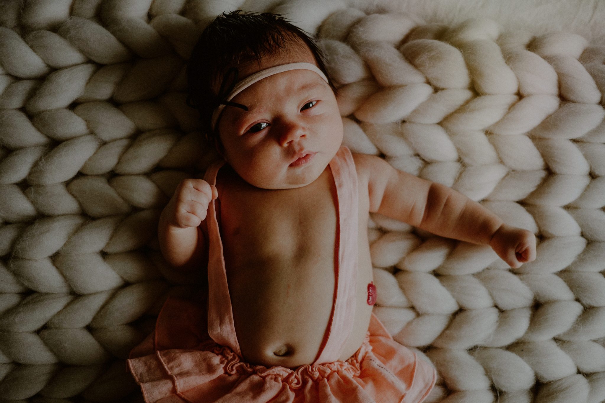 newborn baby photo with baby looking directly at camera