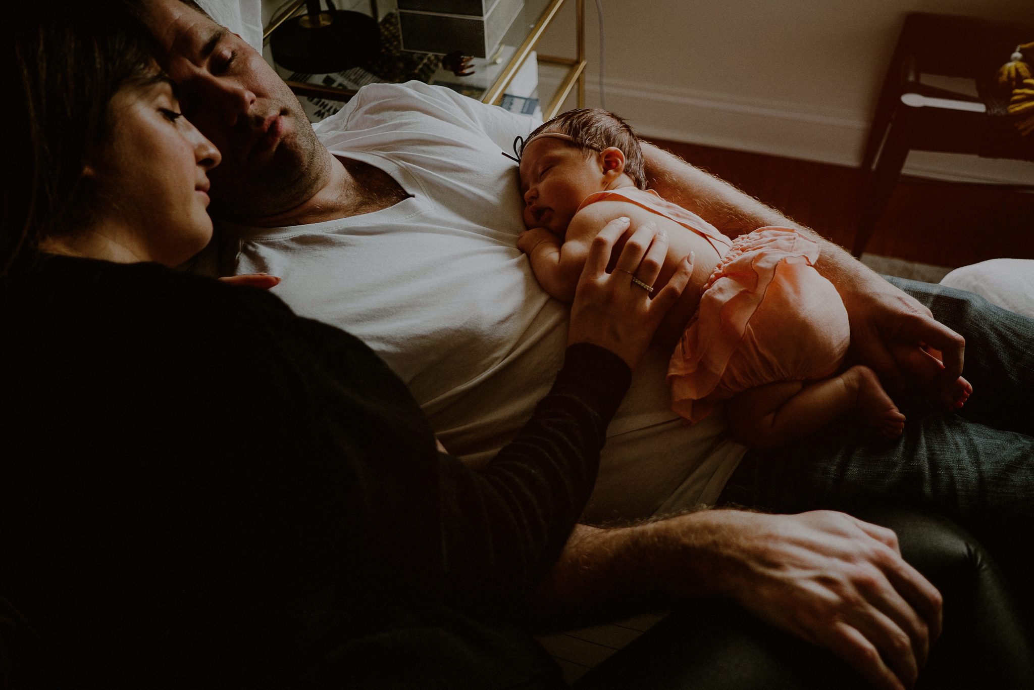 creative family photo of sleeping family together on bed