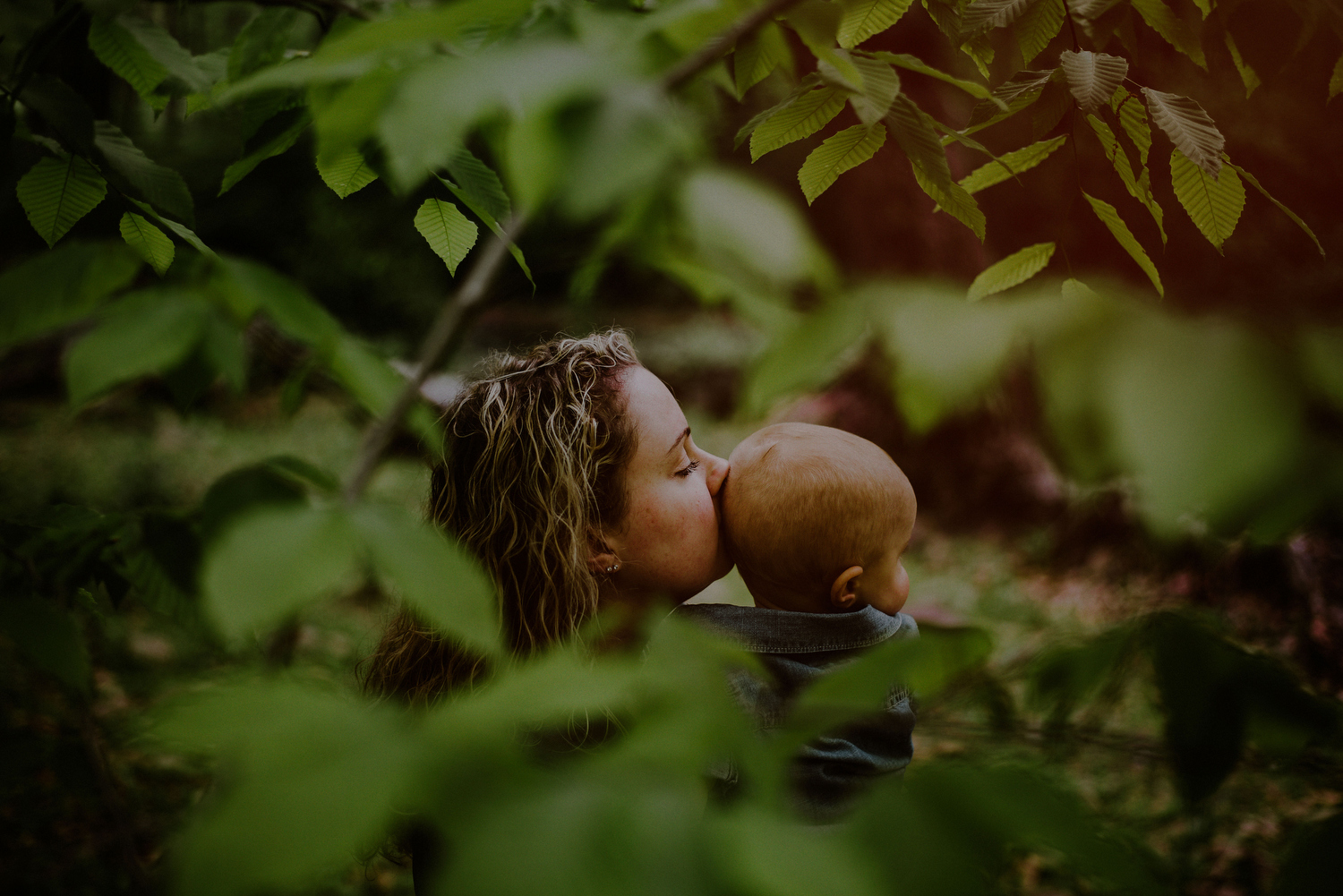 tender moment between mom and son during first birthday photo session