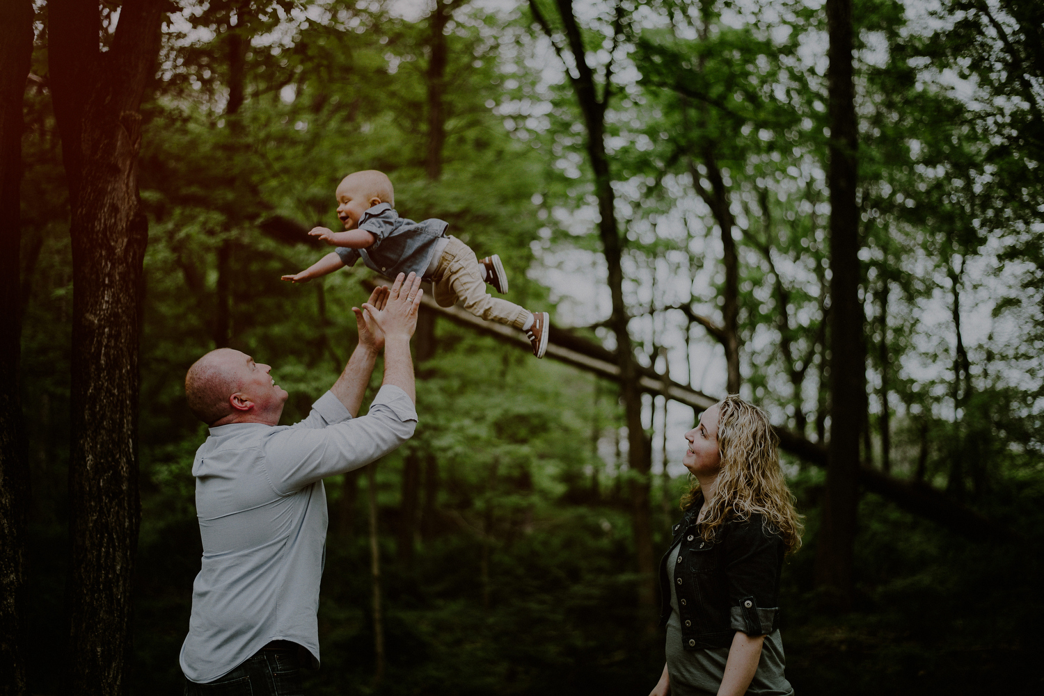 nj family session of mom and dad playing with son