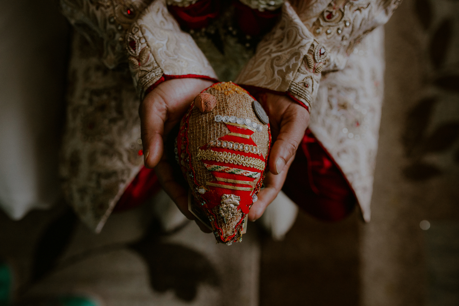groom holds symbolic indian wedding ritual