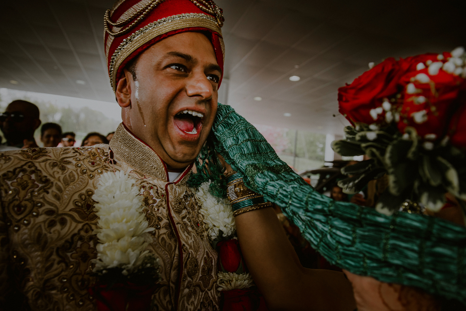 groom sweating as he enters indian wedding ceremony after baraat