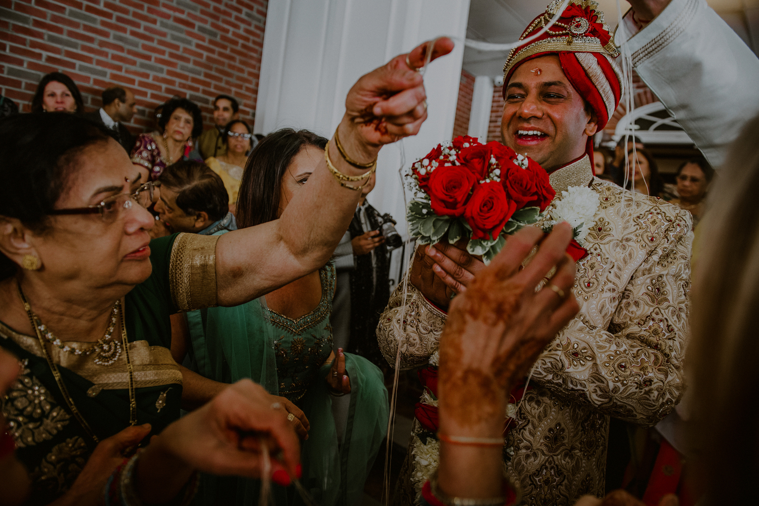 groom enjoys indian wedding rituals after baraat