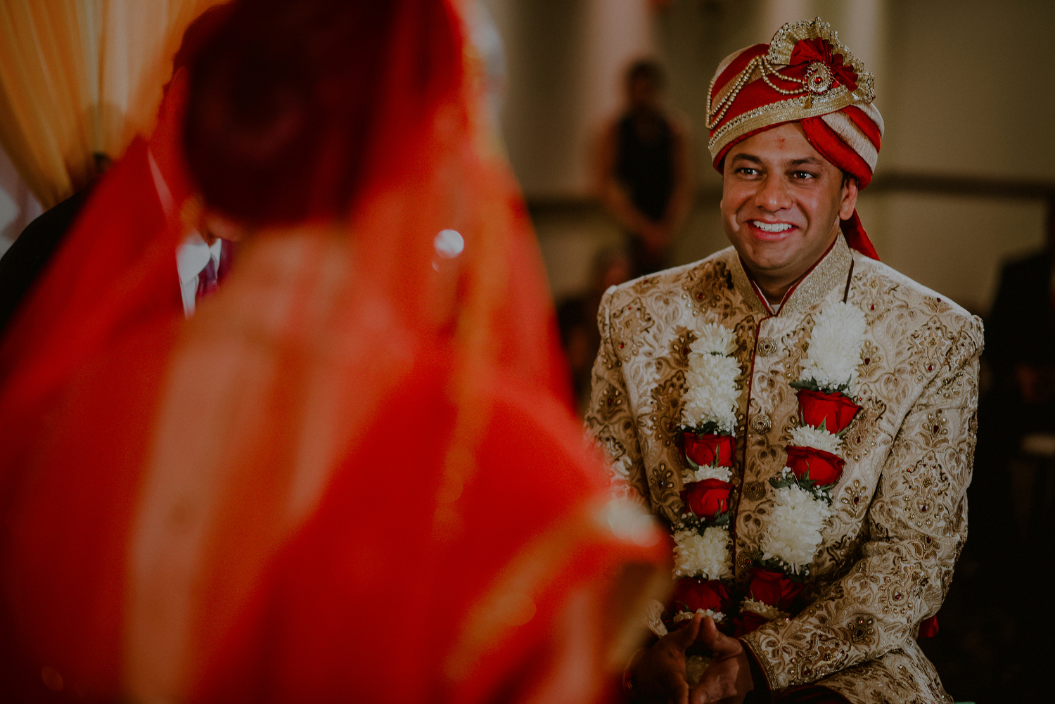 groom looks lovingly at bride during indian wedding ceremony