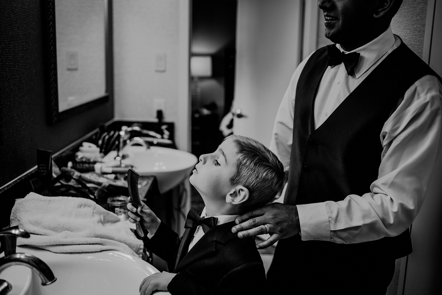 groom helps son get changed during wedding