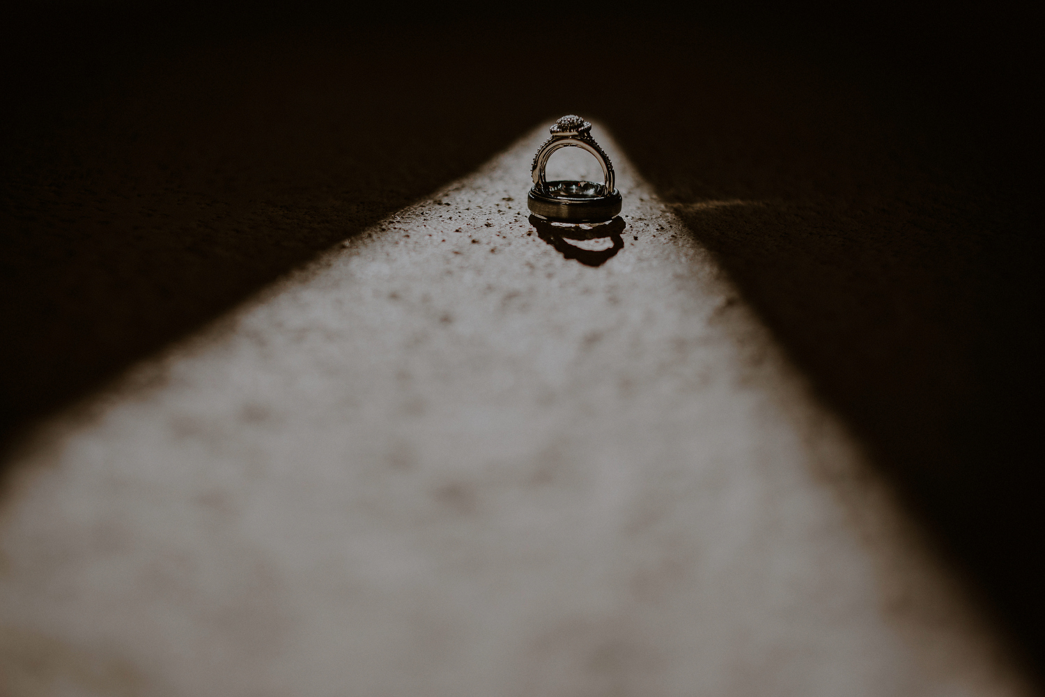 dramatic detail photo of wedding rings