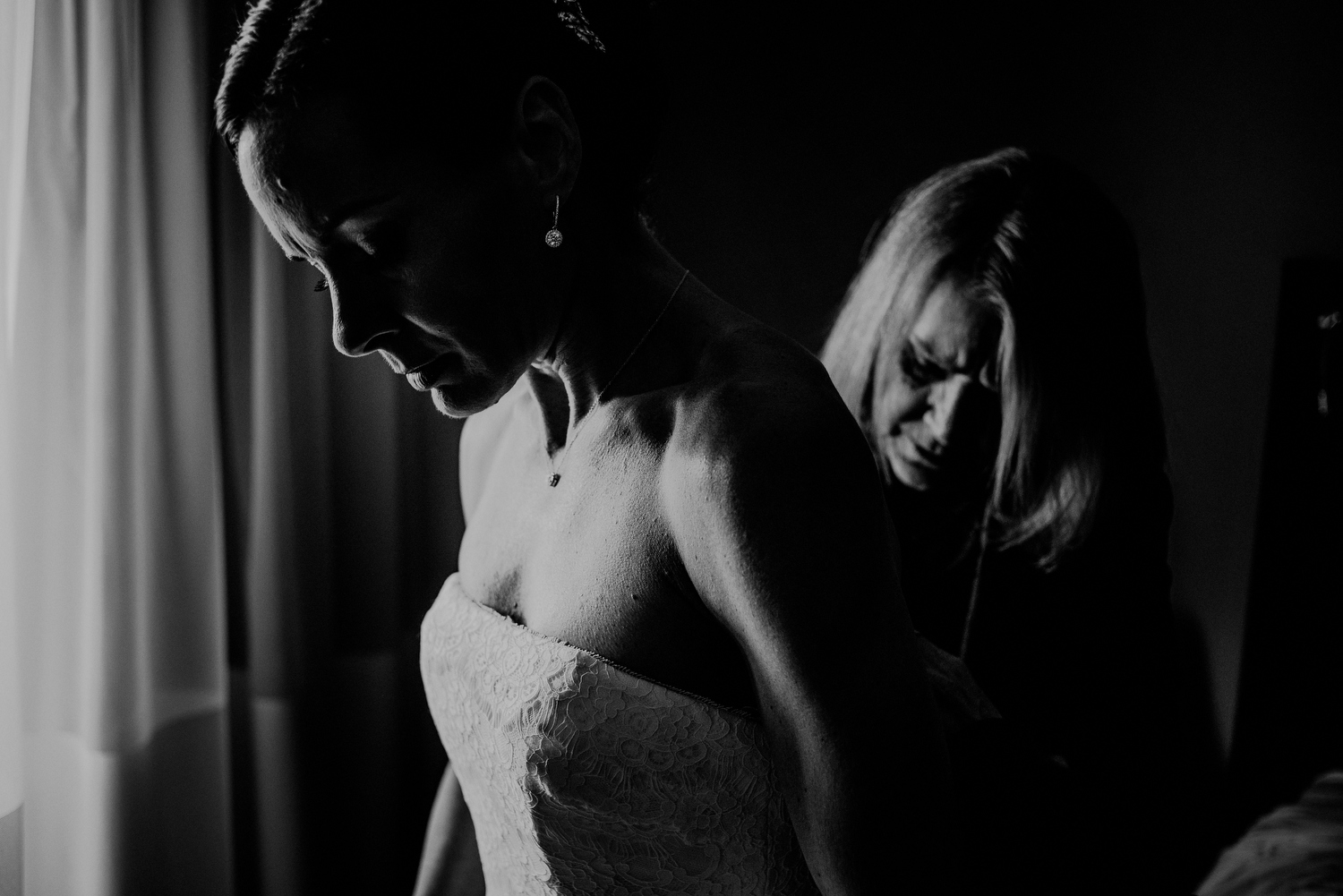 dramatic black and white photo of bride getting ready
