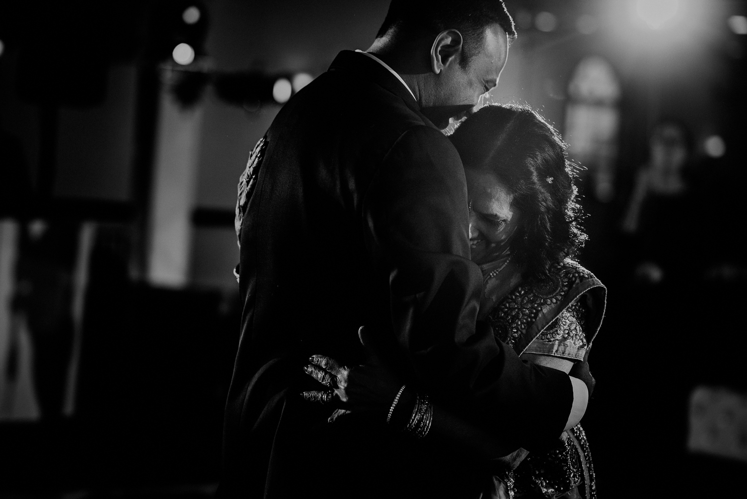 candid moment between groom and mother dance during wedding 