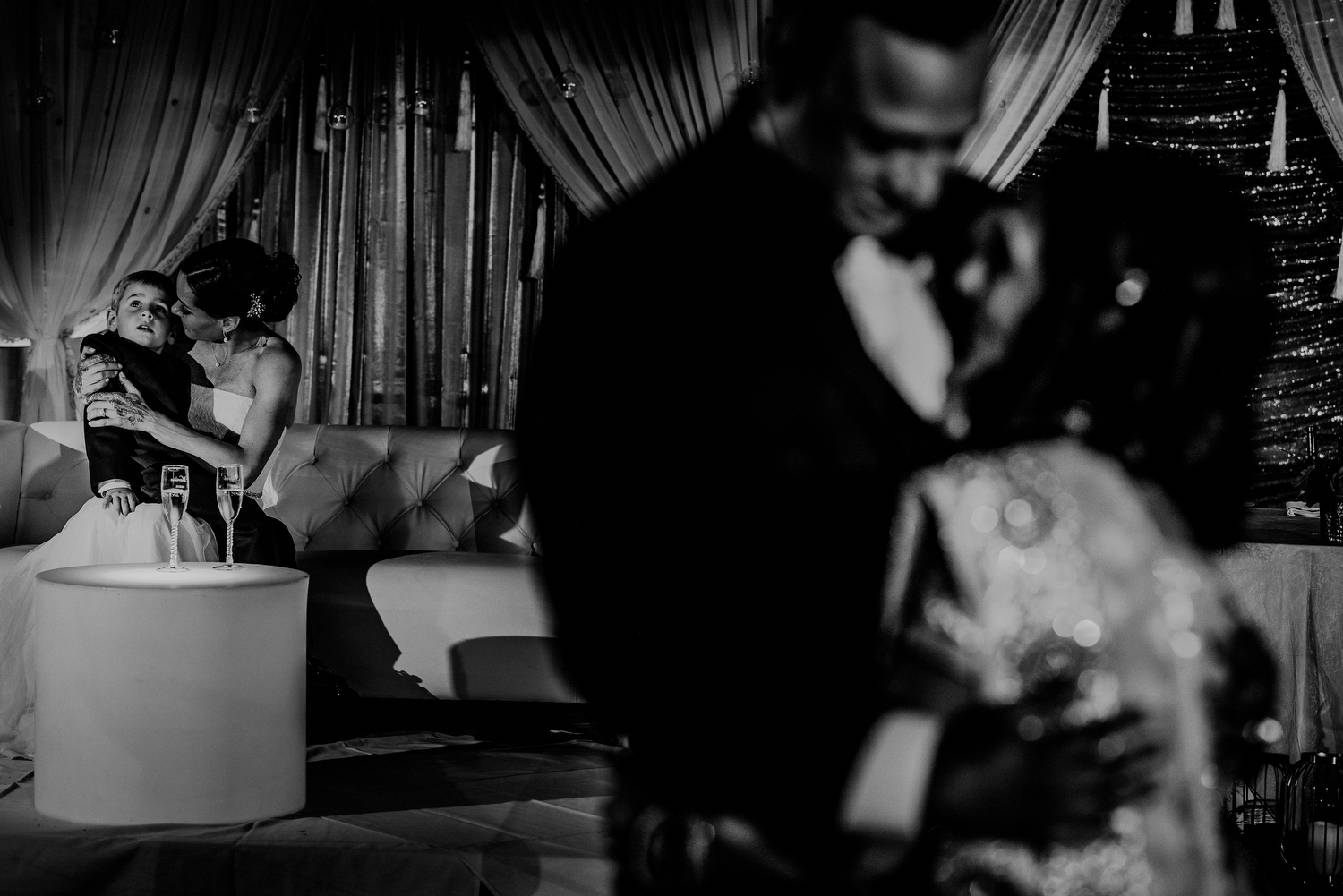 layered image of mother son dance and bride in background during wedding reception