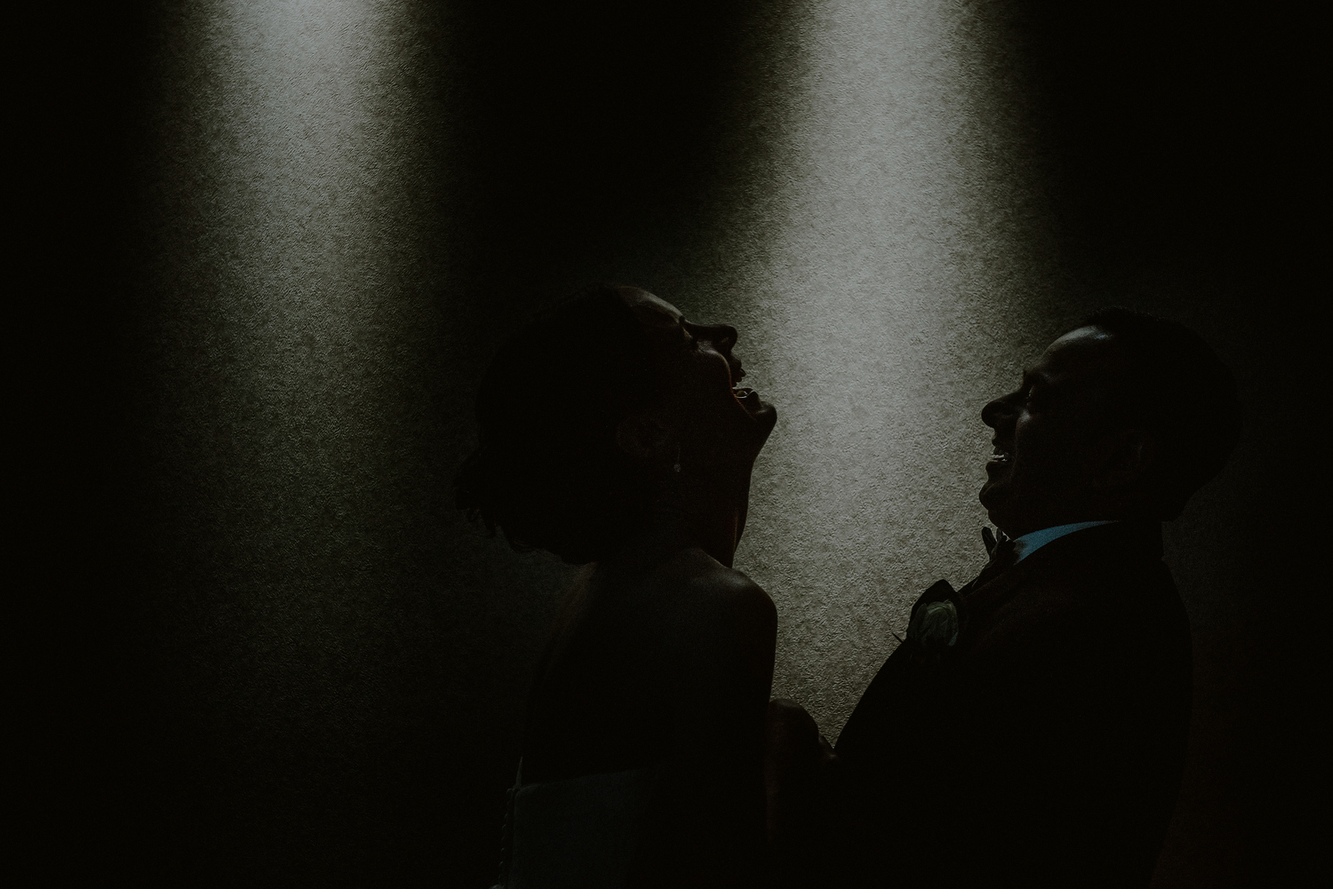 creative end of the night photo of bride and groom laughing