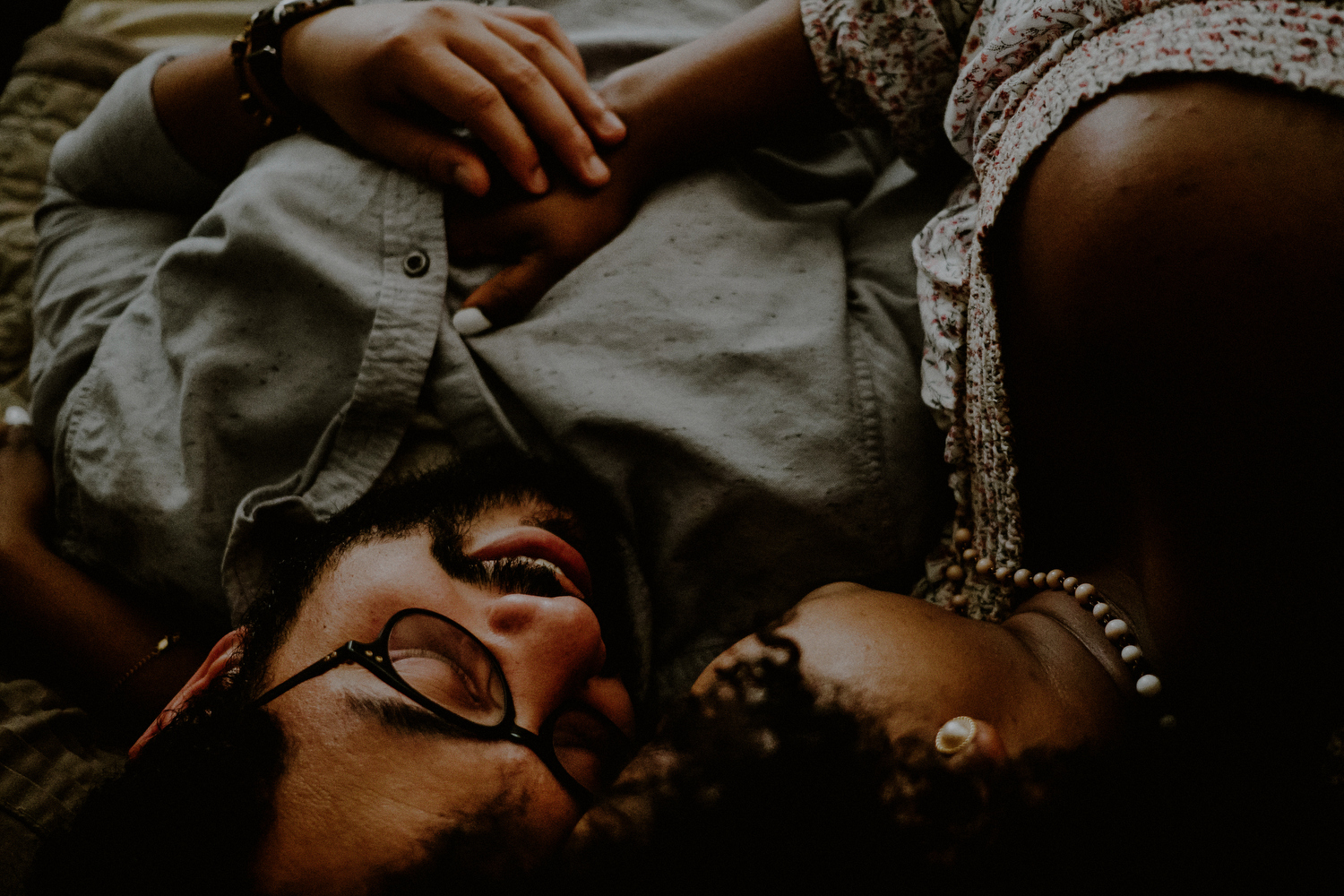 intimate queens ny engagement photos of couple on bed laying down