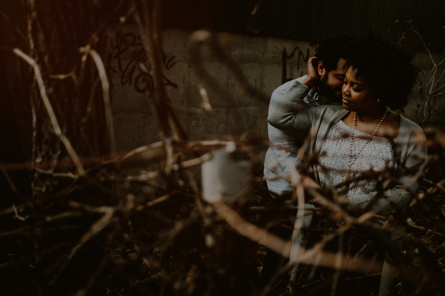 dramatic engagement photo of couple in urban environment