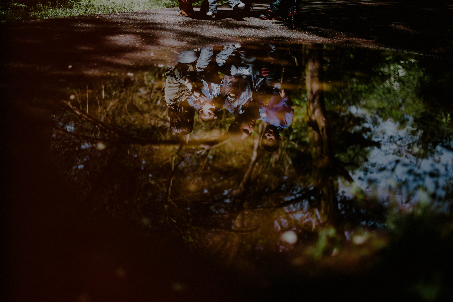 creative photo of family reflection in a puddle