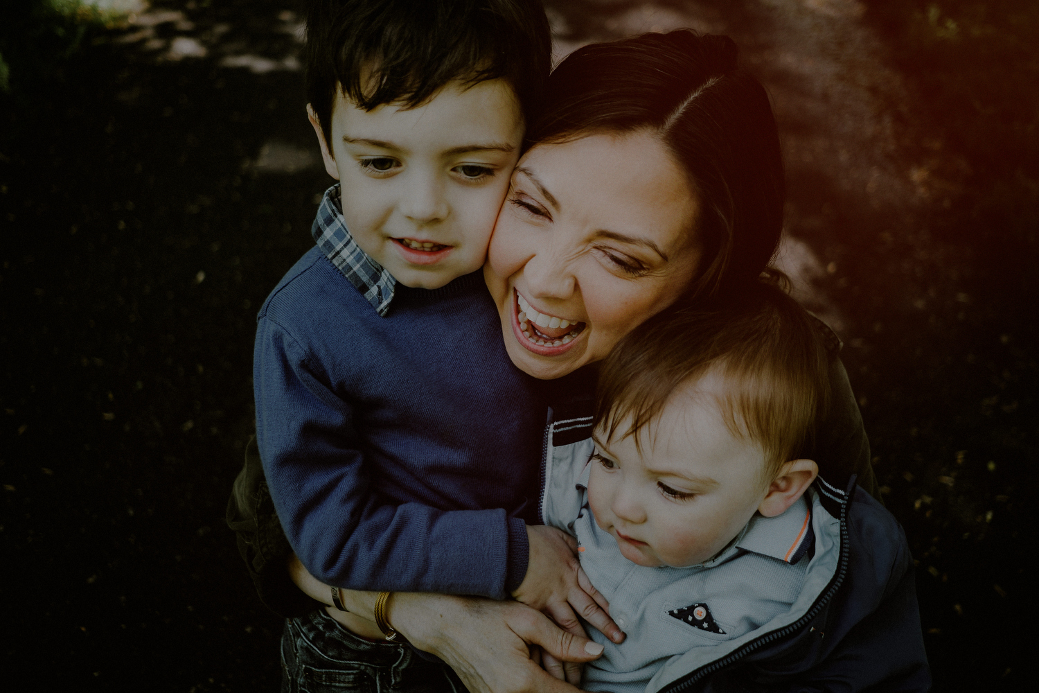 mom laughing with kids during family photo session