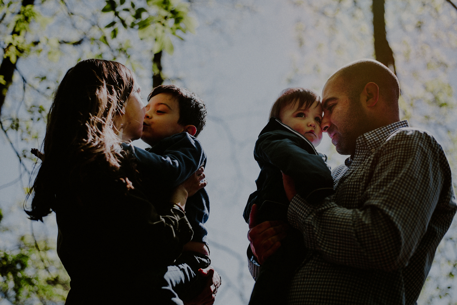 spring family photo against morning sunlight in park