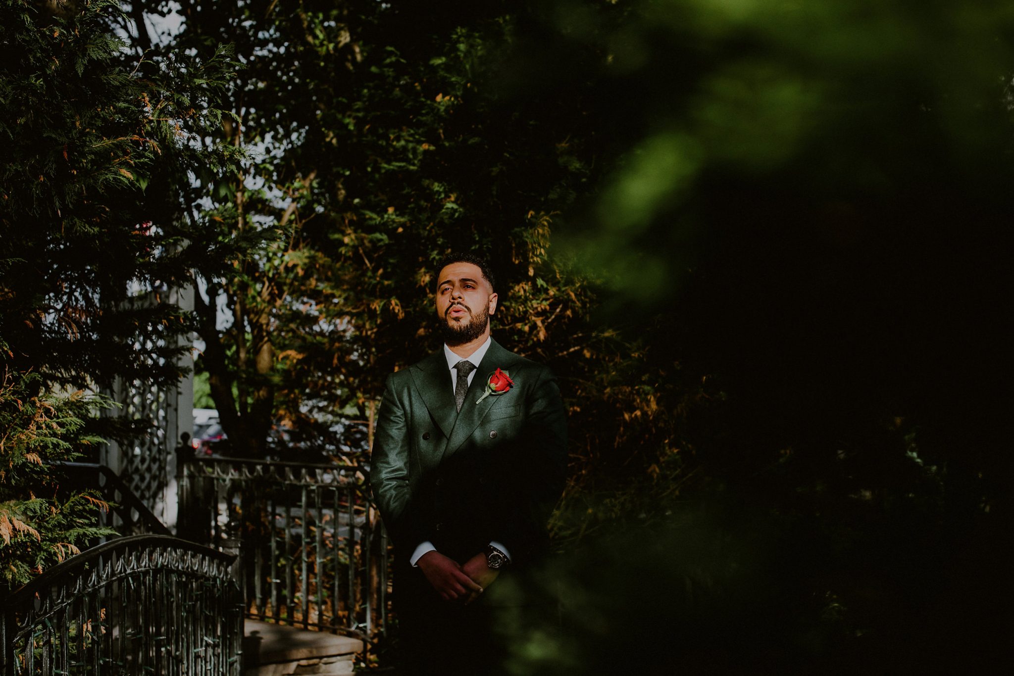 nervous groom waiting in sunlight before first look outside of fox hollow caterers