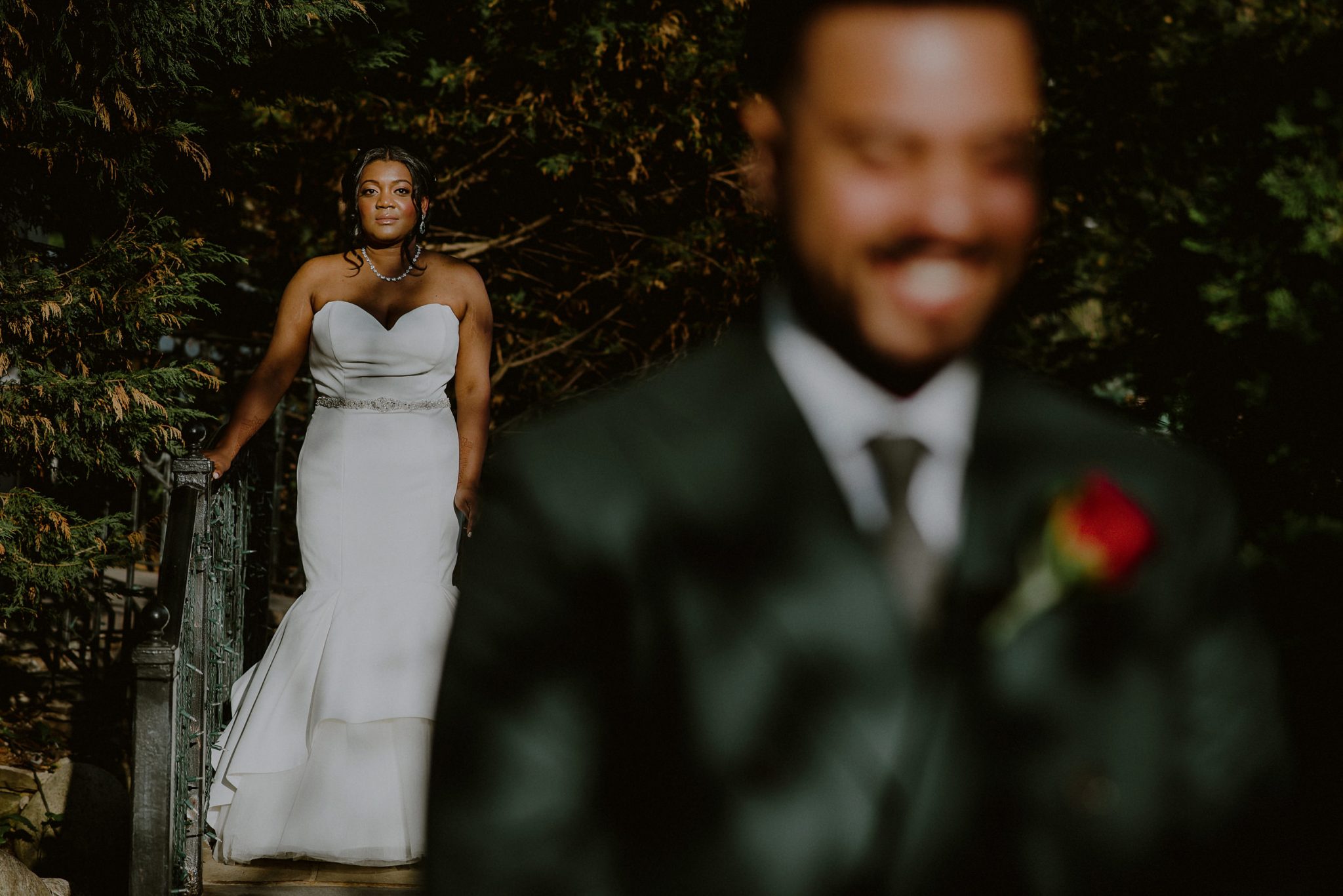 bride waits in distance before first look with groom