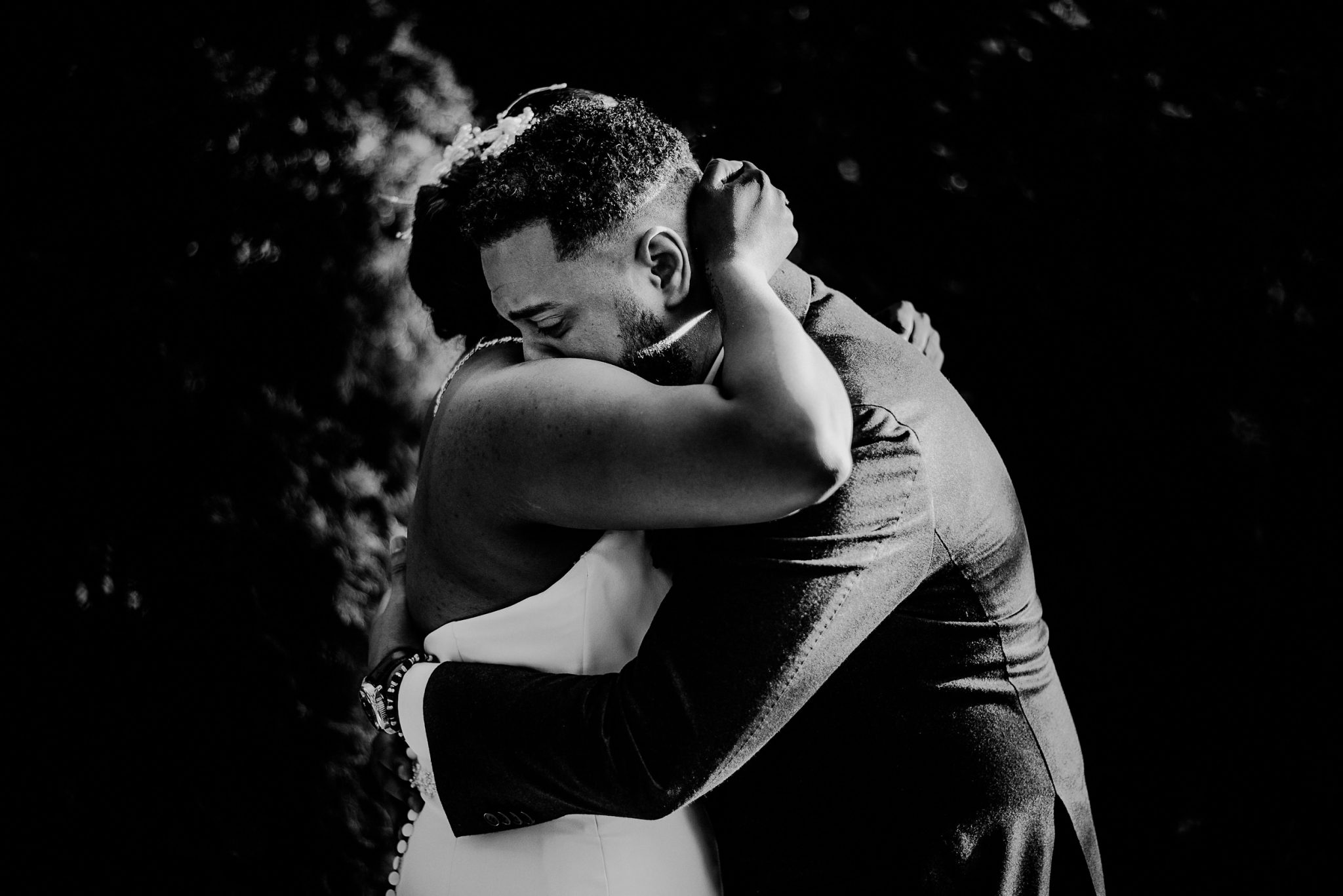 emotional groom during first look embracing with bride