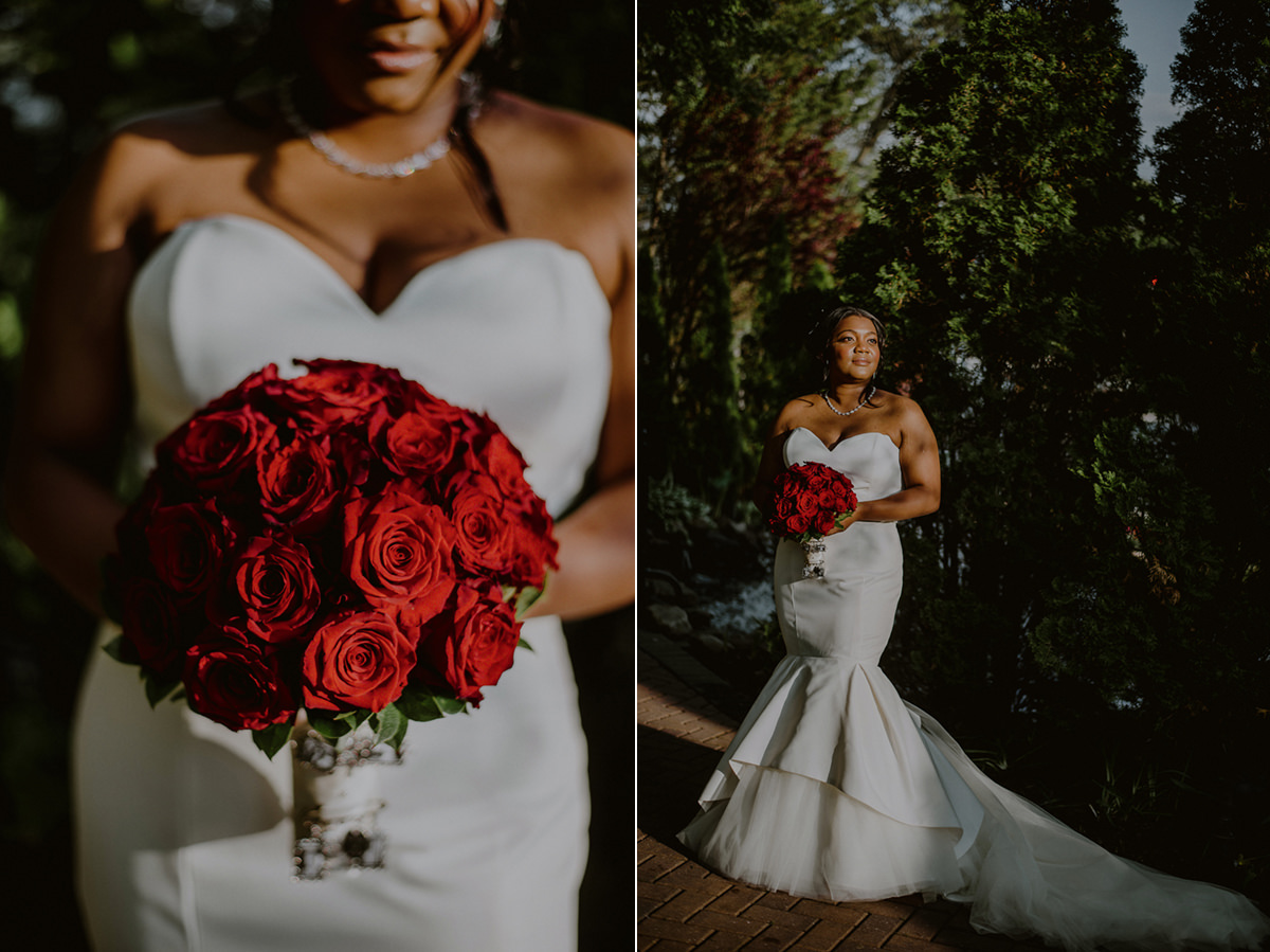 elegant bride posing in sunlight in fitted justin alexander dress and red flowers