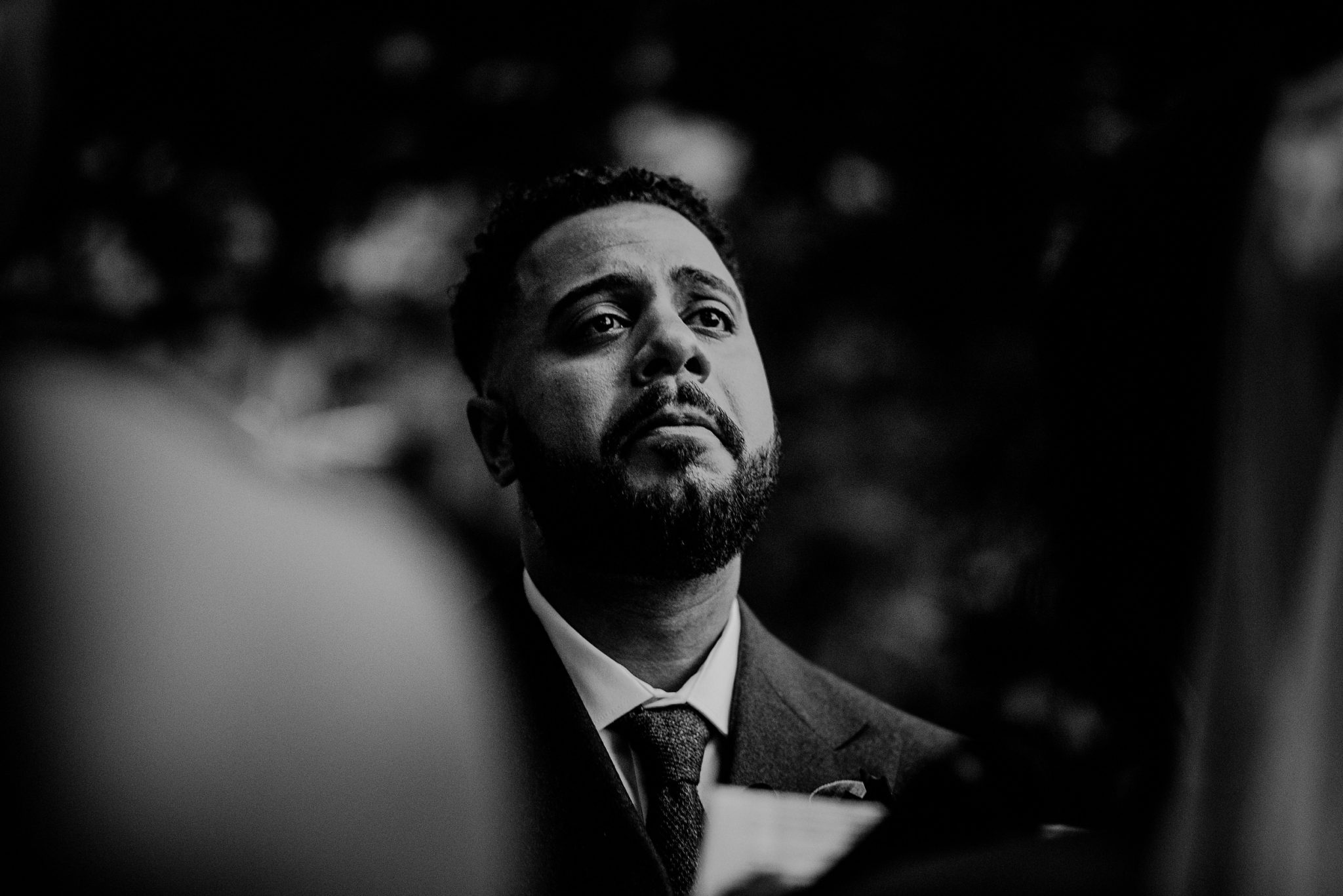 black and white photo of emotional groom 