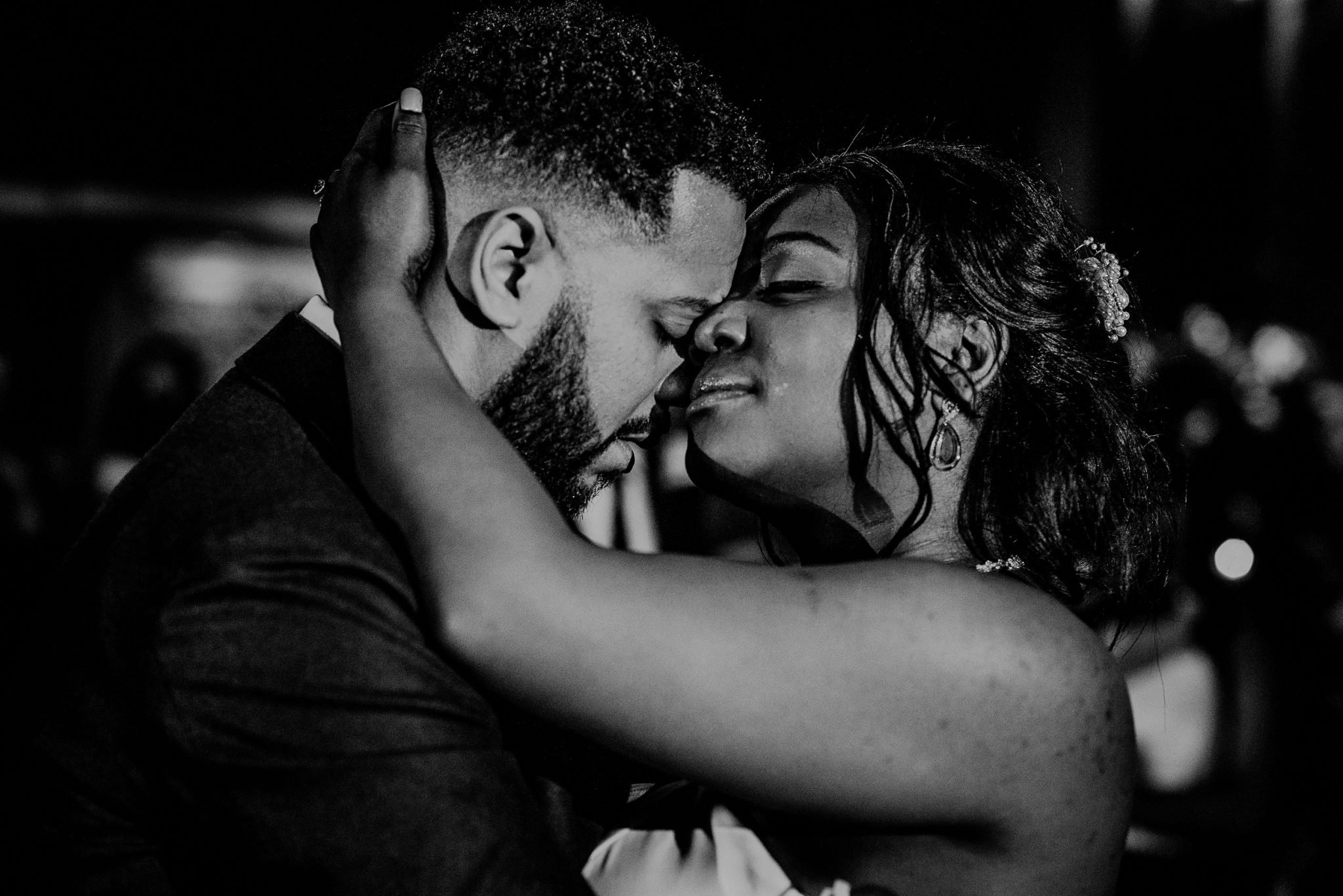 emotional black and white photo of bride and groom first dance