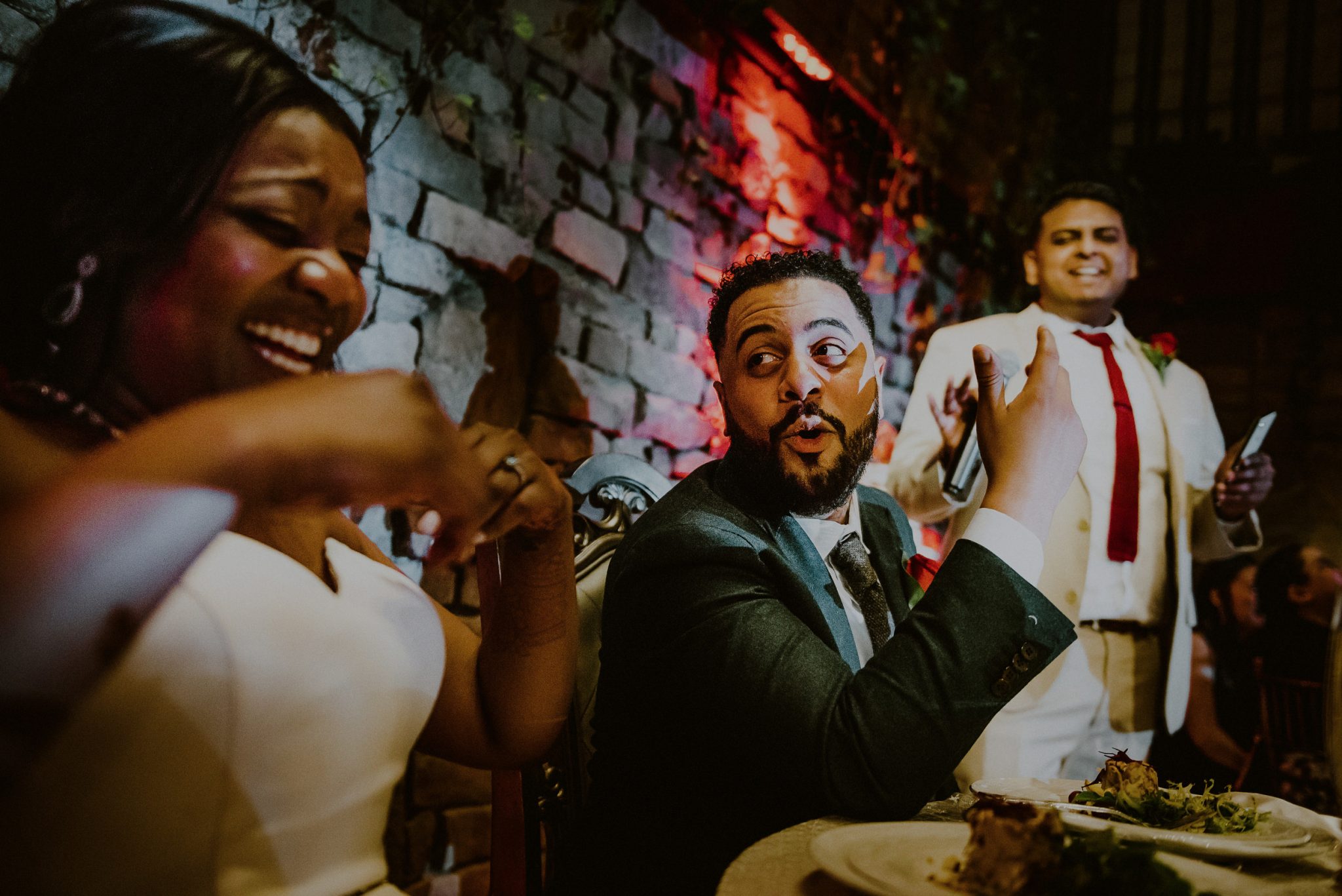 bride and groom laughing during funny best man speech