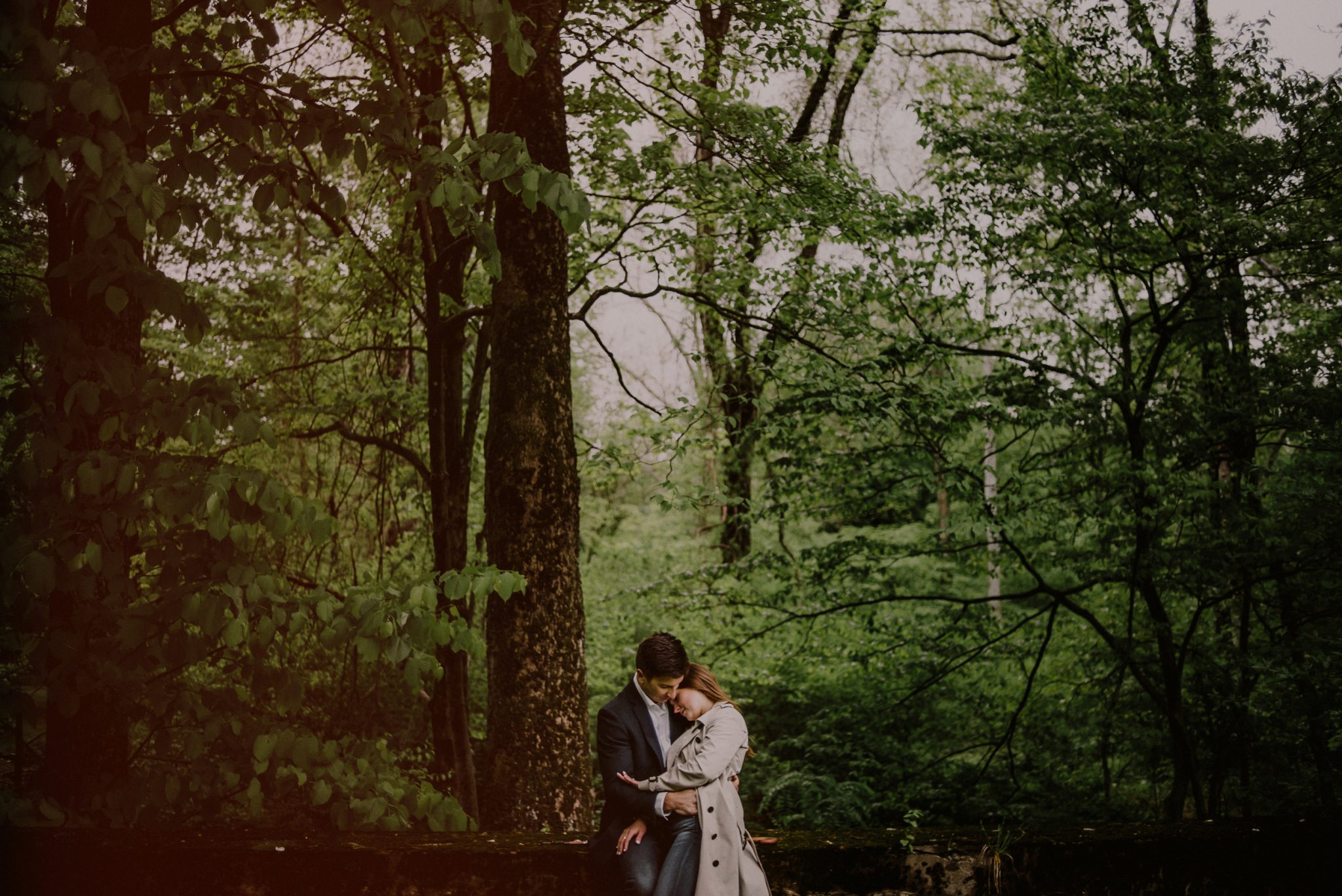 engagement photo of couple in the woods