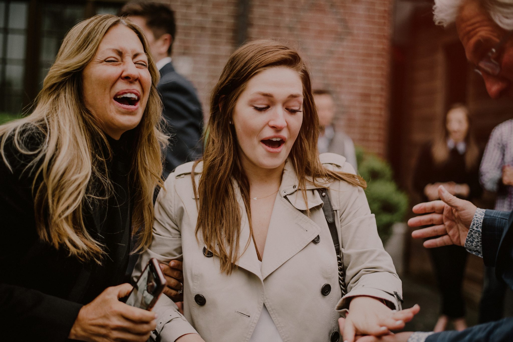 bride looks at engagement ring after surprise proposal