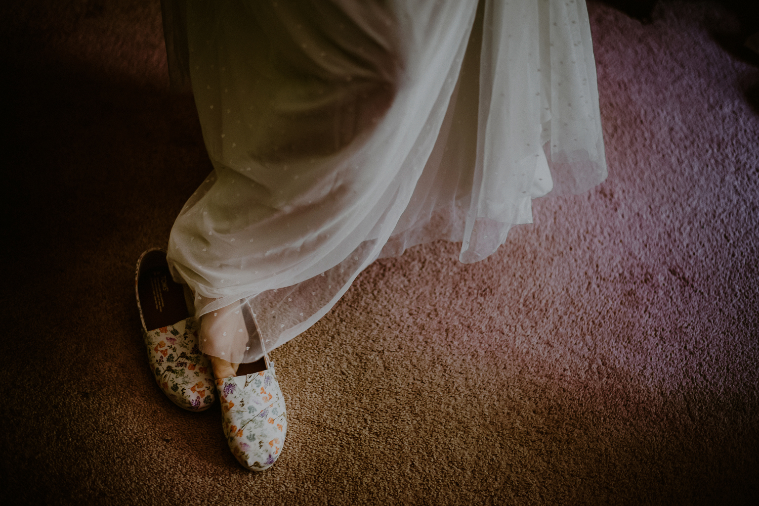 bride puts on toms wedding shoes