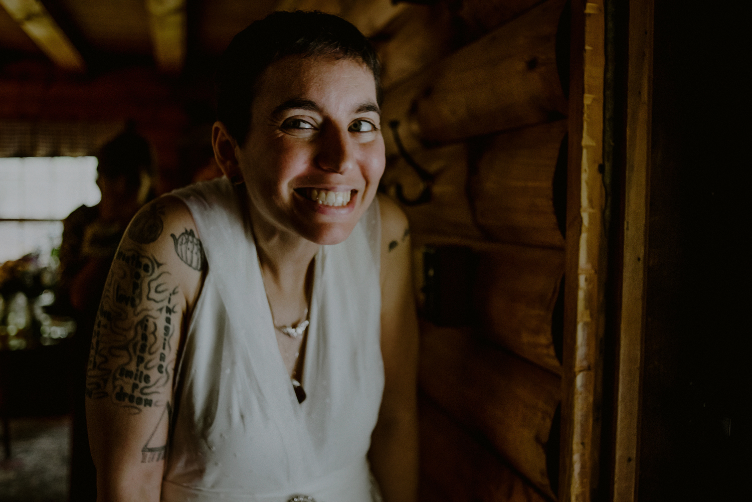 tattooed bride smiles and prepares for first look
