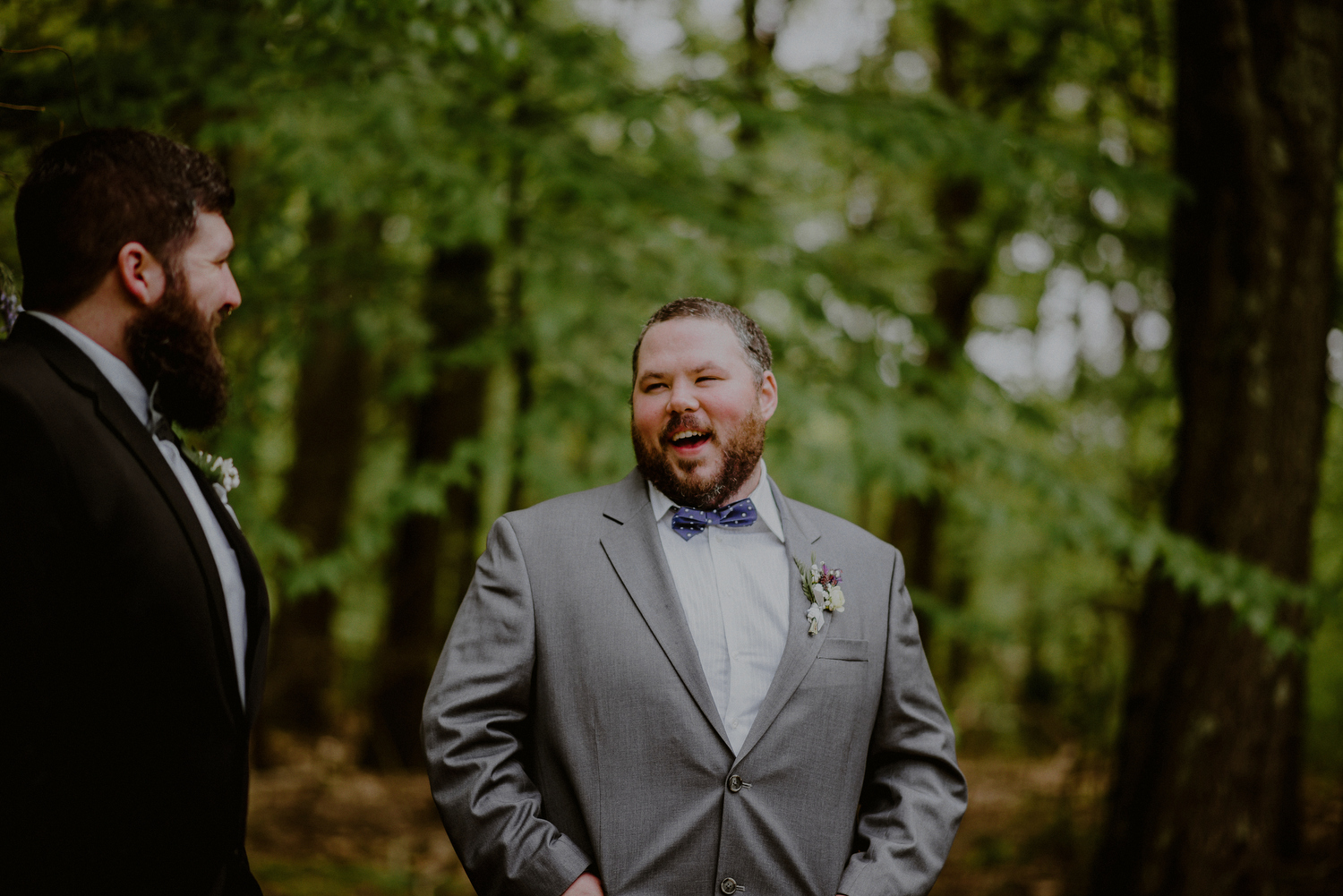 happy groom waits during backyard wedding ceremony