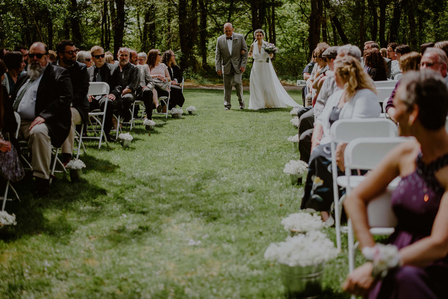 bride walks down aisle in DIY NJ backyard wedding ceremony