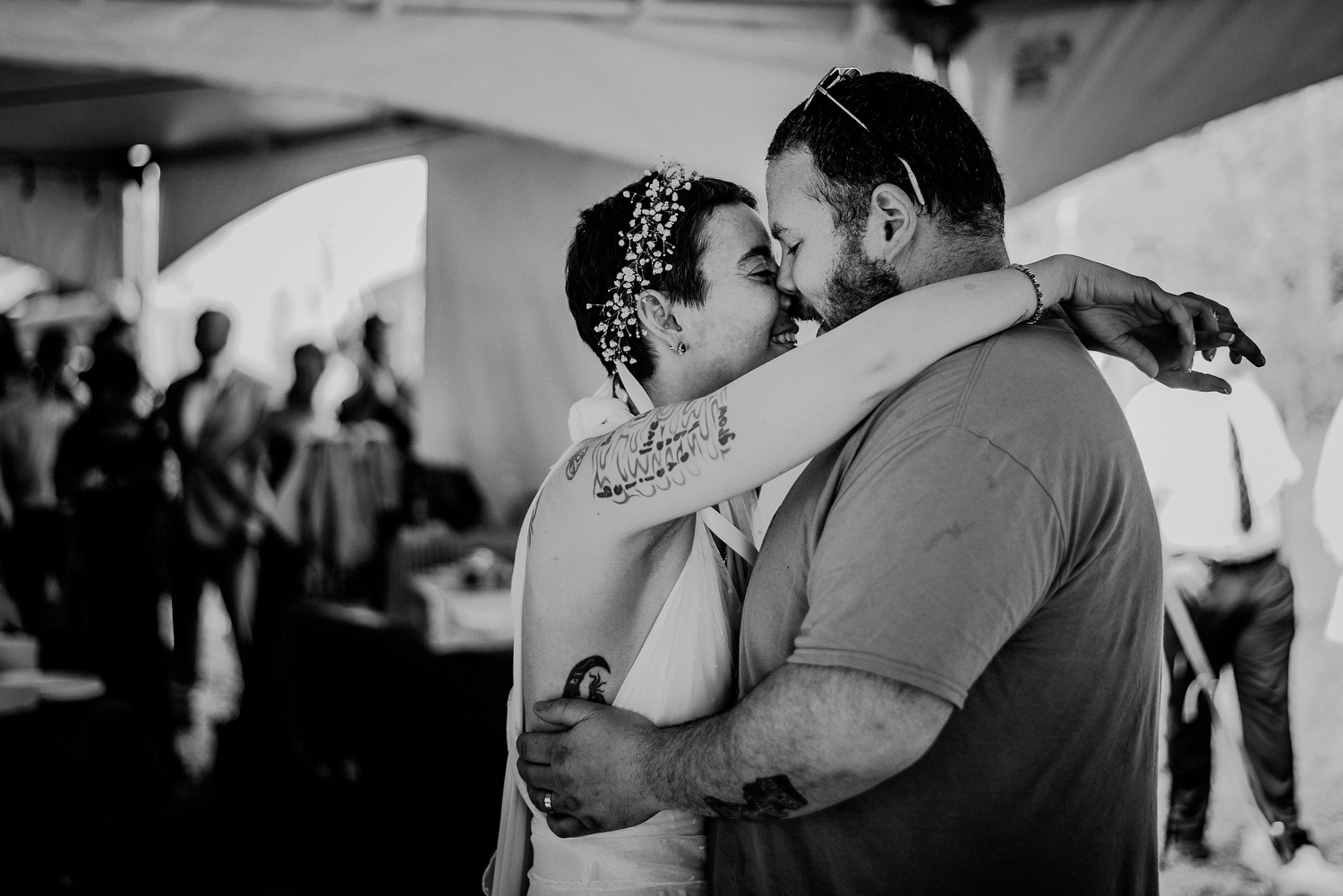 bride and groom first dance under tented backyard wedding reception