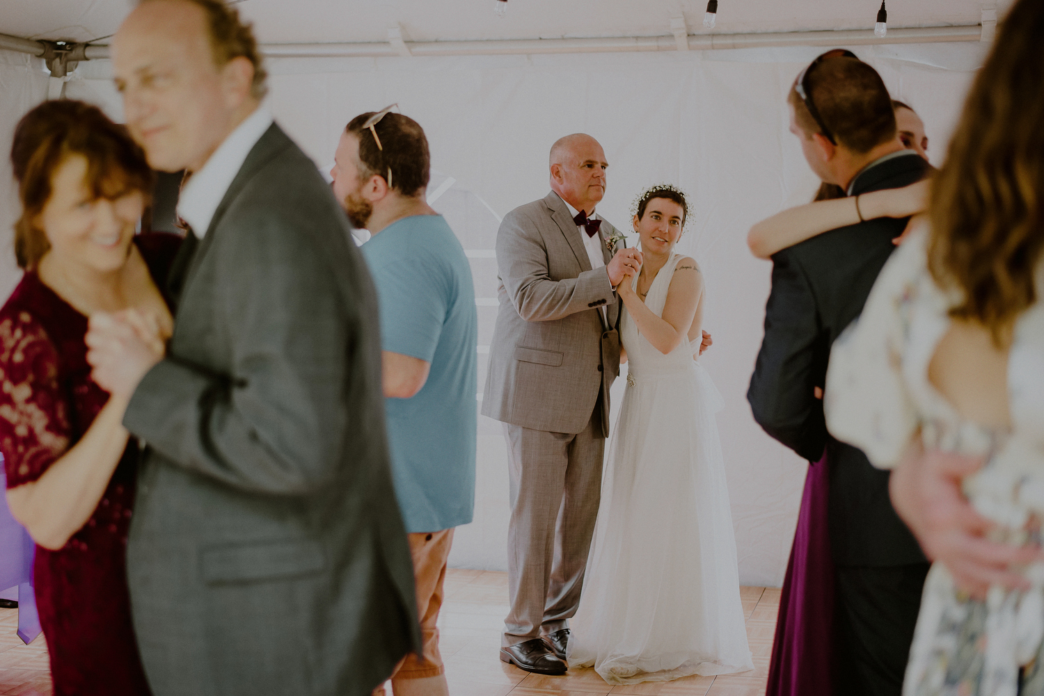 bride and father dance in daytime tented wedding reception