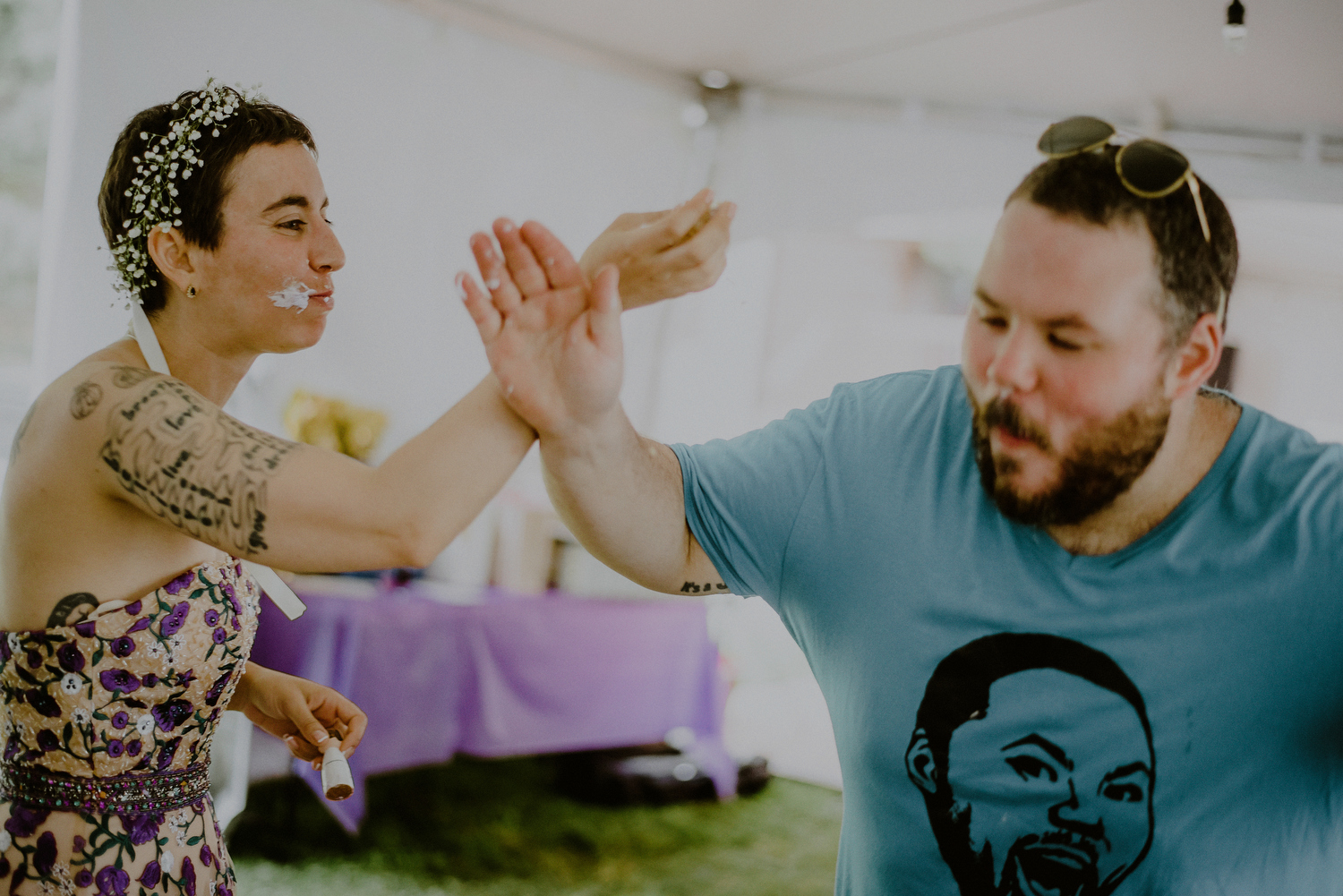 candid cake cutting photo of bride and groom