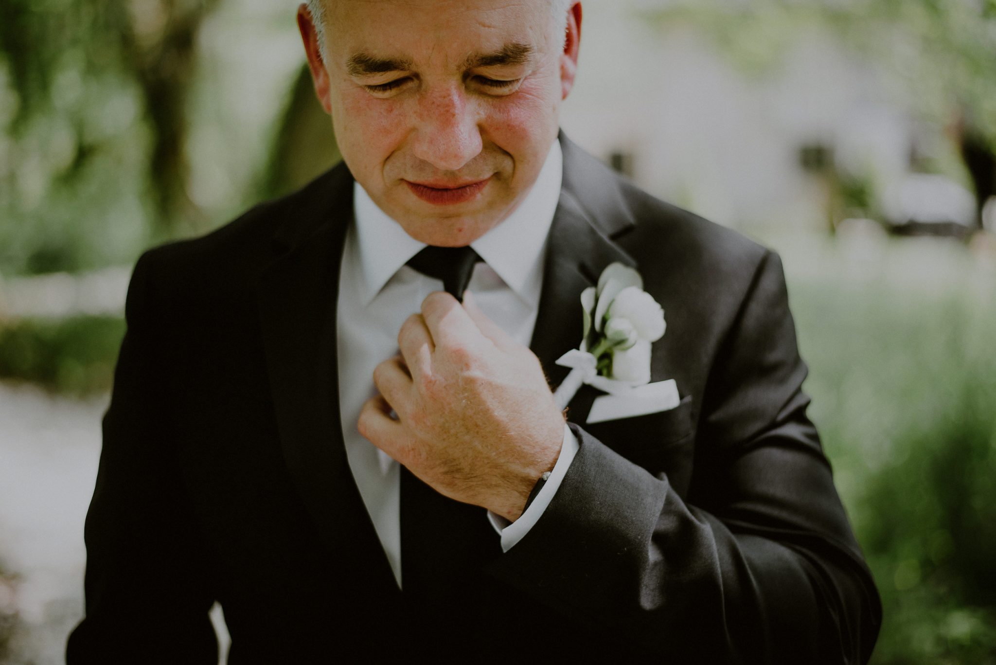 portrait of groom waiting for first look