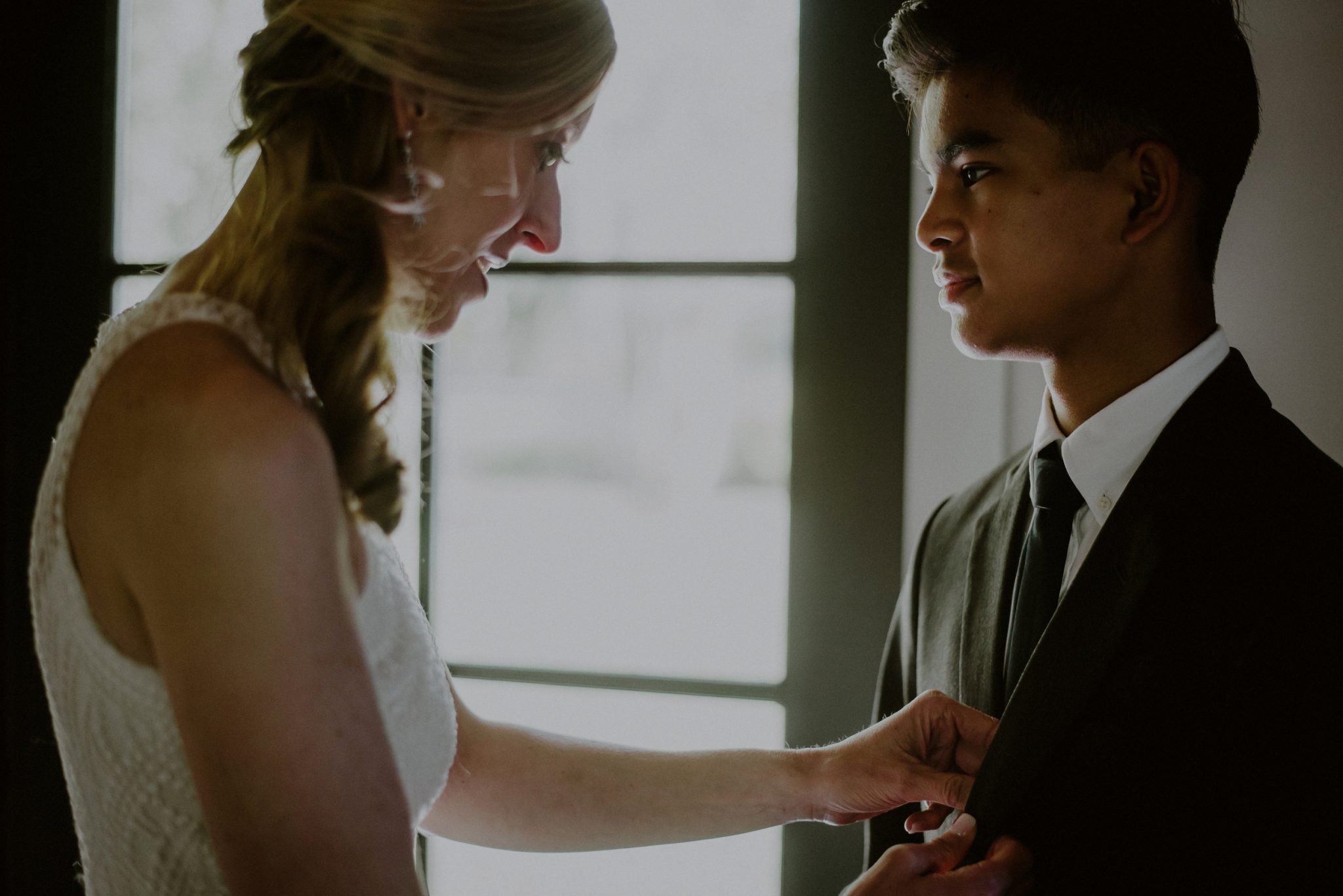 candid driven moment photograph of bride and son