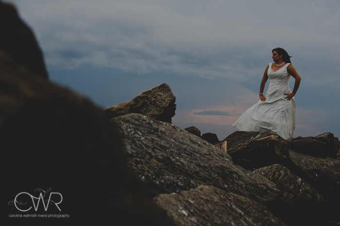 NJ Trash the dress session: bride on rock by stormy clouds