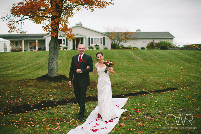tented wedding in upstate ny on private residence as bride and father walk down