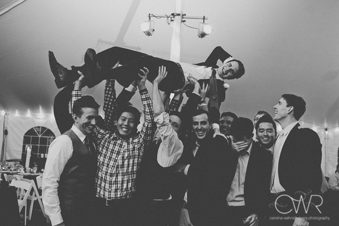 vintage wedding photographer captures fun photo in black and white of groom and his friends