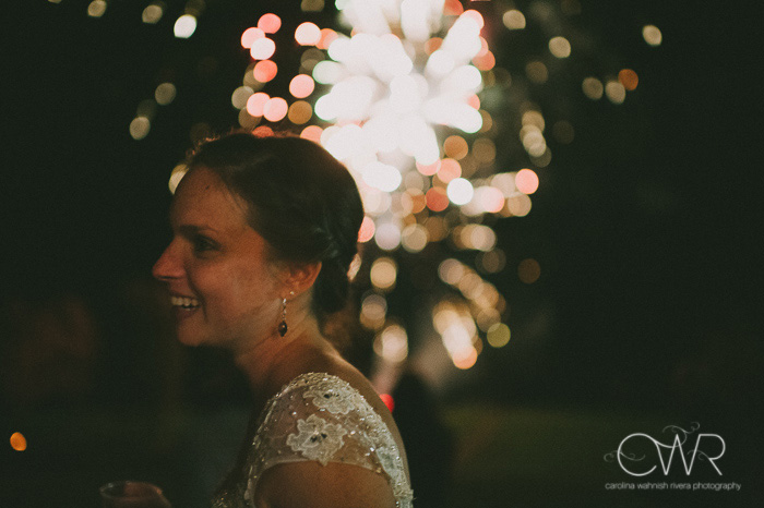 candid wedding photography moment of bride and fireworks in background