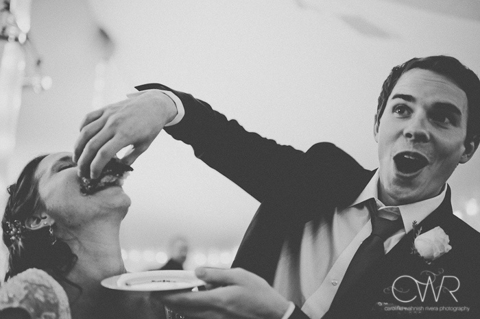 funny wedding cake cutting photo of groom shoving cake in bride's mouth