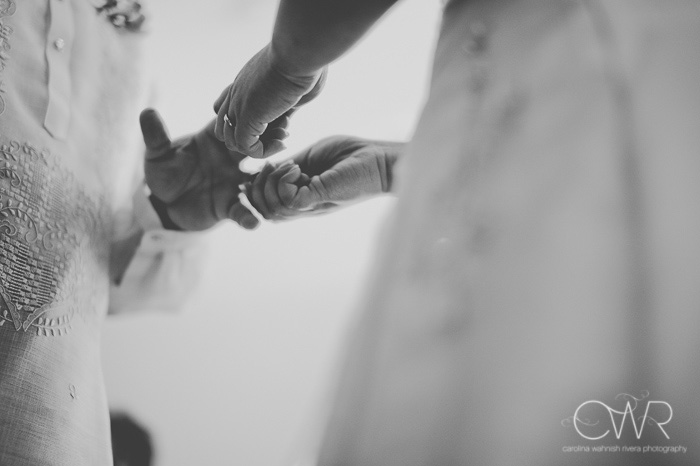 black and white image of interracial wedding ceremony exchange of rings