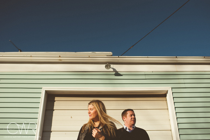 winter engagement photos - simple color scheme engagement portrait of couple framed by garage door