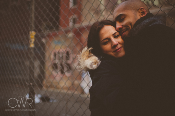urban nyc engagement session - interracial couple kissing in urban environment in soho nyc